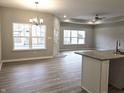 Bright and airy living room with hardwood floors, recessed lighting, and large windows at 2331 Saddle Dr, Shelbyville, IN 46176