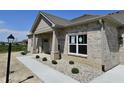 Attractive brick home featuring manicured landscaping and a welcoming front entrance at 2327 Saddle Dr, Shelbyville, IN 46176