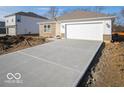 New construction home with a large driveway and unfinished landscaping at 6112 Card Blvd, Indianapolis, IN 46221