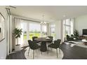 Bright dining area features a modern chandelier, large windows, and stylish furnishings overlooking a spacious backyard at 1105 Gatewick Ct, Greenwood, IN 46143