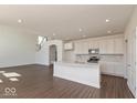 Modern kitchen with a center island, stainless steel appliances, and recessed lighting at 1105 Gatewick Ct, Greenwood, IN 46143