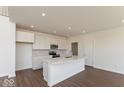 Modern kitchen featuring a large island, white cabinets, and stainless steel appliances at 1105 Gatewick Ct, Greenwood, IN 46143