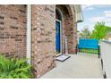 Charming front porch with a blue door, brick archway, and cozy seating at 5707 Kensington Blvd, Plainfield, IN 46168