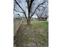 Large backyard featuring a mature trees and an expansive grassy area, offering outdoor space at 5625 Gateway Dr, Indianapolis, IN 46254