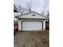 Detached garage with white siding and a black accent trim; ideal for secure parking and storage at 5625 Gateway Dr, Indianapolis, IN 46254