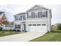 Beautiful two-story home boasting a spacious driveway and a well-kept lawn at 975 Red Hills Ct, Lebanon, IN 46052