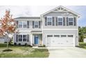 Traditional two-story home featuring gray siding, black shutters, and a well-maintained front yard at 975 Red Hills Ct, Lebanon, IN 46052