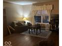 Cozy living area with natural light from the large window, next to a comfortable seating area at 1418 Osprey Way, Greenwood, IN 46143