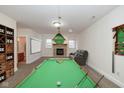 Entertainment basement features a pool table, fireplace, and a cozy seating area at 7290 Lockford Walk N, Avon, IN 46123