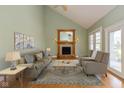 Inviting living room with a fireplace, neutral-toned furniture, and natural light from the large windows at 7290 Lockford Walk N, Avon, IN 46123