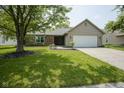 Inviting single-story home with a manicured lawn, brick details, and an attached two-car garage at 8391 Inland Dr, Avon, IN 46123