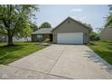 Well-maintained single-story home with an attached garage, brick facade, and a spacious driveway at 8391 Inland Dr, Avon, IN 46123