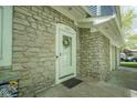 Charming front door with stone surround, wreath, and house number, inviting you to make this house your home at 1127 Grant Cir, Cicero, IN 46034