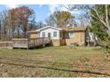 Brick home featuring a wooden deck and a sprawling green backyard at 6436 E Hadley Rd, Mooresville, IN 46158