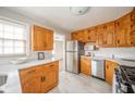 Bright kitchen with oak cabinets, stainless steel appliances, and quartz countertops at 217 Federal Dr, Anderson, IN 46013