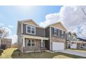 Charming two-story home with gray siding, stone accents, and an attached two-car garage at 8131 Trailstay Dr, Camby, IN 46113