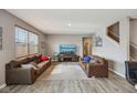 Inviting living room with hardwood floors, neutral paint, large windows, and comfortable leather sofas at 8131 Trailstay Dr, Camby, IN 46113