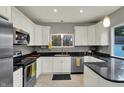 Bright kitchen featuring granite countertops, stainless appliances, and custom white cabinets at 8240 Shelbyville Rd, Indianapolis, IN 46259