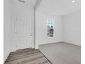 Bright foyer with a gray carpet, a front door with sidelights, and a large window letting in lots of light at 908 Stonehaven Dr, Indianapolis, IN 46239