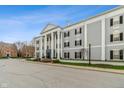 Attractive exterior with classical columns, symmetrical design, black shutters, and well-maintained landscaping at 12820 University Cres # 2D, Carmel, IN 46032