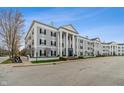 Attractive exterior with classical columns, symmetrical design, black shutters, and well-maintained landscaping at 12820 University Cres # 2D, Carmel, IN 46032