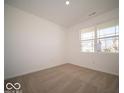 Cozy bedroom with neutral carpet, a large window, and ample natural light at 301 Lar Lan Dr, Danville, IN 46122