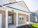 Welcoming entryway with white columns and a gray front door at 301 Lar Lan Dr, Danville, IN 46122