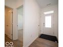 Bright foyer with hardwood flooring and a view of the adjacent rooms at 301 Lar Lan Dr, Danville, IN 46122