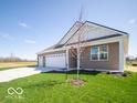 Well-maintained home featuring a brick exterior and a three-car garage at 301 Lar Lan Dr, Danville, IN 46122
