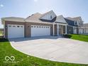 Spacious home featuring a large three-car garage and a wide driveway for ample parking at 301 Lar Lan Dr, Danville, IN 46122