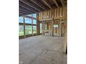 A bright living room featuring large window framing for natural light, with exposed beams and wood framework at 8030 Totton Ct, Zionsville, IN 46077