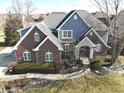 Charming two-story home featuring a brick facade, stone accents, and well-manicured landscaping at 9856 Wild Turkey Row, Fishers, IN 46055