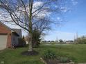 Spacious backyard with a lush green lawn and tranquil pond view, perfect for outdoor enjoyment and relaxation at 744 Helm Dr, Avon, IN 46123