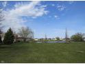 Scenic community pond surrounded by lush green space and walking paths offers a serene and picturesque setting at 744 Helm Dr, Avon, IN 46123