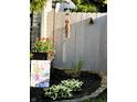Backyard with garden, bird feeder, decorative flag, and white picket fence at 5441 E 17Th St, Indianapolis, IN 46218