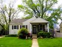 Inviting single story home featuring well-manicured lawn and charming covered front porch at 5441 E 17Th St, Indianapolis, IN 46218
