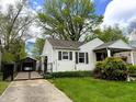 Lovely home with detached garage, lush lawn, and a cozy covered front porch at 5441 E 17Th St, Indianapolis, IN 46218