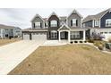 Charming two-story home with a three car garage, covered porch, and landscaped front yard at 10811 Wild Orchard Ln, Indianapolis, IN 46239