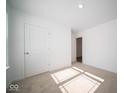Spacious bedroom with neutral decor, carpet flooring, and a large window at 1426 Bluebonnet Pl, Shelbyville, IN 46176