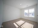 Well-lit bedroom with neutral-colored walls and carpeted floors at 1426 Bluebonnet Pl, Shelbyville, IN 46176