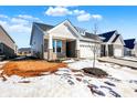 Two-story house with gray siding and a stone facade at 16972 Adler Ln, Noblesville, IN 46060
