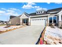 Modern home's exterior features a white garage door and stone accents at 16972 Adler Ln, Noblesville, IN 46060