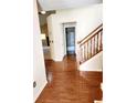 Spacious entryway with hardwood floors and staircase at 4835 Franklin Villas Dr, Indianapolis, IN 46237