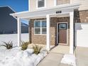 Brick front porch with brown door and white columns at 7430 Big Bend Blvd, Camby, IN 46113