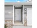 White front door with glass panel and gray siding exterior at 1501 Coen Ct, Columbus, IN 47201