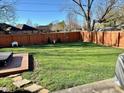 Large fenced backyard with manicured lawn, decorative shed and hot tub at 562 Nelson Dr, Brownsburg, IN 46112