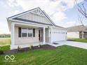 Inviting single-story home featuring a welcoming covered front porch and manicured lawn with shrubbery at 132 Velvet Hat Rd, Danville, IN 46122