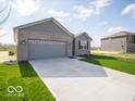 A charming single-story home featuring a two-car garage, a long driveway, and a well-maintained lawn at 120 Velvet Hat Rd, Danville, IN 46122