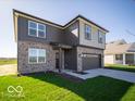 Charming two-story home with a brick and siding exterior, gray garage door, and landscaped front yard at 126 Velvet Hat Rd, Danville, IN 46122