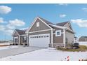 Rear view of the house showcasing the garage and landscaping at 7098 Sterling Way, Brownsburg, IN 46112